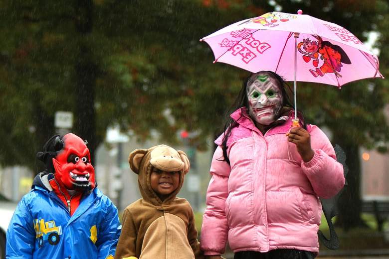 Siblings trick-or-treating in the rain in Massachusetts.