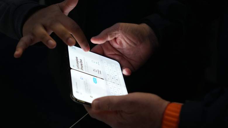 Customers look at iPhone Duo folding smart phones at an Apple store in London on October 23, 2026.